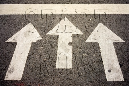 Inspiration quote " Start now" on aerial view of road with three arrows on the pavement indicating the way forwardの写真素材
