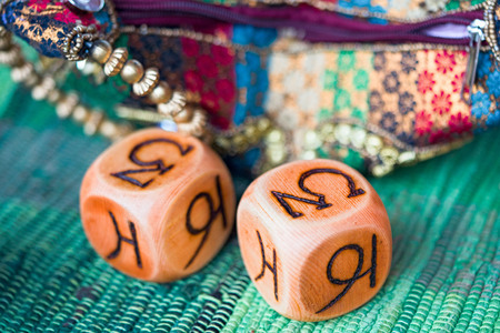 two wooden astrology cubes with zodiac signs