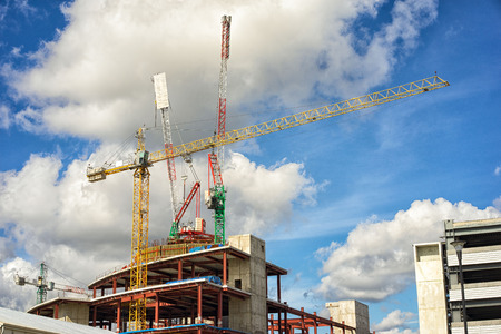 Crane and building construction site against blue sky