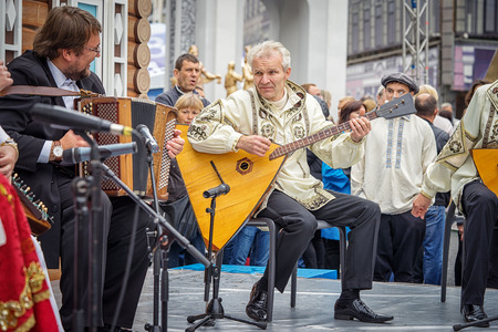 Moscow, Russia - September 11, 2016: Moscow City Day. Moscow residents and guests celebrate the 869 anniversary of the city. Performance on Tverskaya Street. Music band performs play balalaikas.のeditorial素材