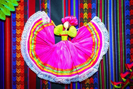 paper figure of mexican dancer on a traditional carpetの写真素材