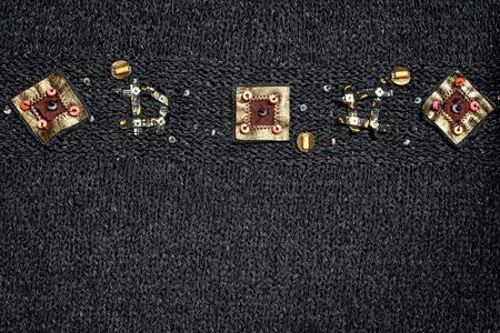 knitted black background with a geometrical ornament border in the top and copy space for your textの写真素材