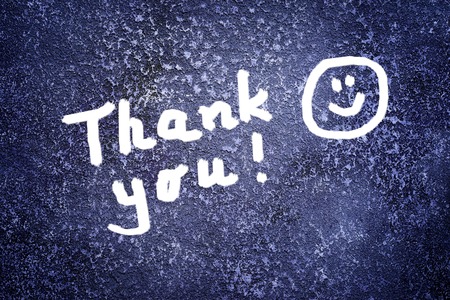 Thank you inscription and smile on the abstract grunge dark navy backgroundの写真素材