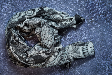 Grey scarf on cement dark background. Top view with copy spaceの写真素材