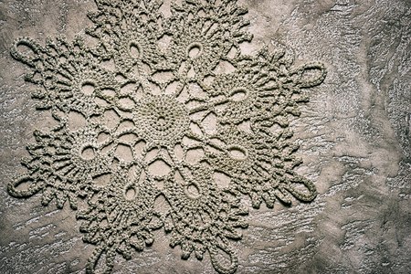 background for handmade blog. beige neutral tones. copy space under the inscription. handmade crochet doily on cement background. suitable for inscription over the picture.の写真素材