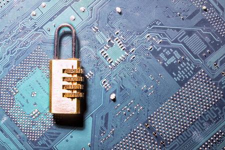 combination padlock on motherboard computer for security conceptの写真素材