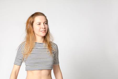 Portrait of caucasian young purposeful enthusiastic woman with an active lifestyle. Studio shot, copy space.の写真素材