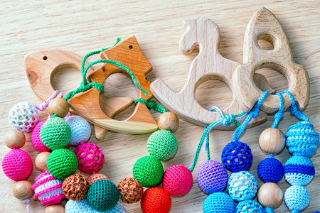 Necklace made from knitted beads and wooden toys for the baby sitting in a sling. Knitted beads....