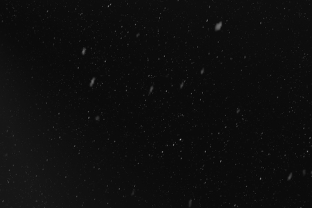 Rain or snow fall concept. Falling raindrops on black background. Just change blending mode to "Screen" and use it. Uniform droplet distribution, realistic snow from the top downwards. Light spots.の写真素材