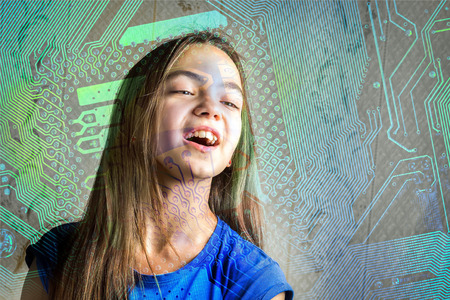 Portrait of a 11 year old girl with her mouth open through a circuit board silhouette. Concept of new generation, computer science and informatics lessons, cyber society.の写真素材
