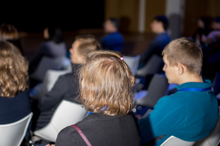 Business Conferences Concepts and Ideas. Group of People Attending Conference and Listening to the...