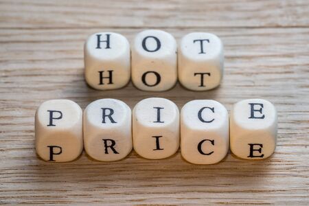 Hot price text on a wooden cubes on a wooden background, copy spaceの写真素材