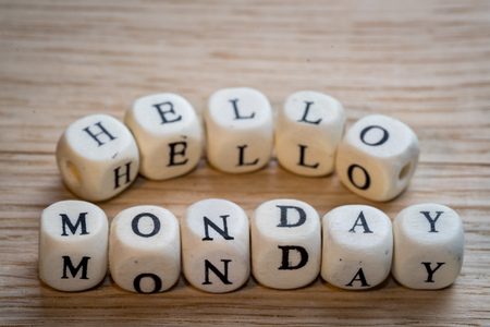 Hello monday text on a wooden cubes on a wooden tableの写真素材