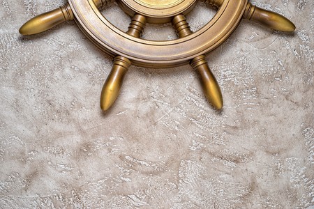Part of steering weel on a beige background with copy space. Close up top view. Holiday travel conceptual backgroundの写真素材