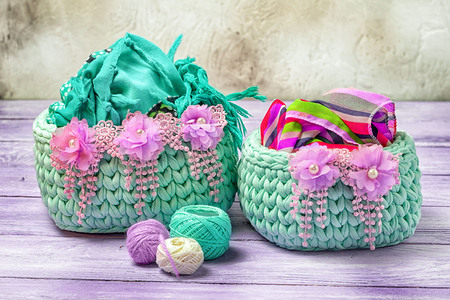 Handmade cosiness. Two crocheted baskets for feminine trifles, decorated with floral lace.の写真素材