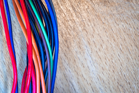 wires on a wooden background with copy spaceの写真素材