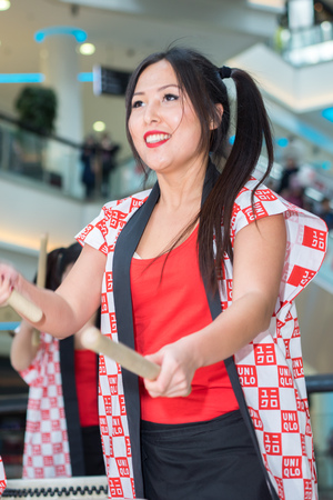 Moscow, Russia - March 25, 2017: group of Japanese Taiko drummers girls perform in Kaleidoscope shopping center on the at the opening of a new store UNIQLO Unique Clothing Warehouse.のeditorial素材