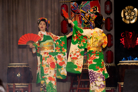 Moscow, Russia - 4 November, 2016: IV citywide action festival  "Night of the Arts". Theatrical dance performance in the Japanese style in DK Nagorniy. Two geishas with fans on the stage.のeditorial素材