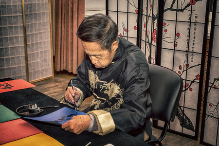 Moscow, Russia - 4 November, 2016: IV citywide action festival  "Night of the Arts". Calligrapher writes characters on colored paper in DK Nagorniy.のeditorial素材