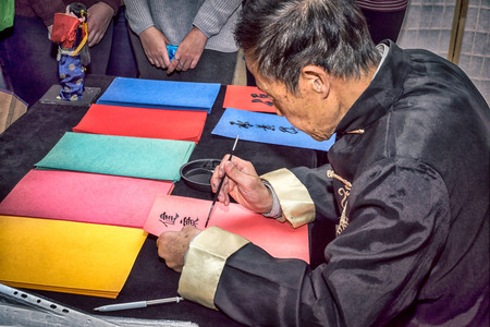Moscow, Russia - 4 November, 2016: IV citywide action festival  "Night of the Arts". Calligrapher writes characters on colored paper in DK Nagorniy.のeditorial素材
