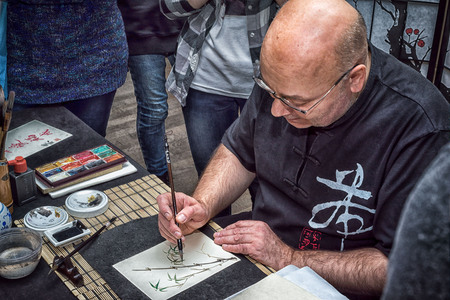 Moscow, Russia - 4 November, 2016: IV citywide action festival  "Night of the Arts". Calligrapher draw bamboo in DK Nagorniy.のeditorial素材