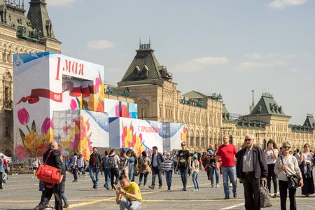 Moscow, Russia - April 30, 2017: people walking on the Red Square near the GUM. Holiday posters on the day of May 1.のeditorial素材