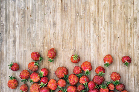 strawberries on a wooden table, top view with copy space for your textの写真素材