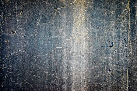 texture of a dark grey cement wall with cracks and stripsの写真素材