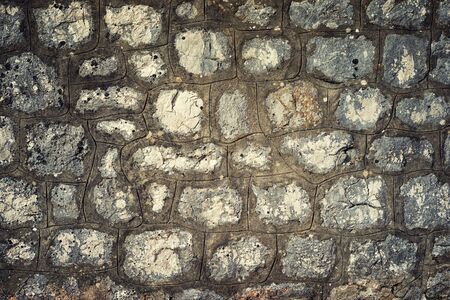 gray faded ancient medieval stone wallの写真素材