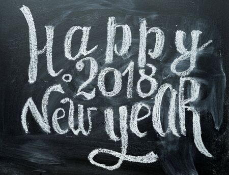 Happy 2018 new year card template with white chalk greetings on blackboard.の写真素材