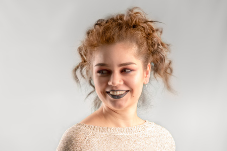Caucasian smiling beautiful woman with curly hair on white background.の写真素材