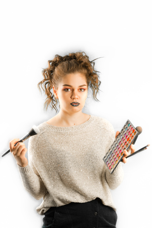 Cosmetics, health and beauty concept - beautiful woman with mascara. Woman getting make-up isolated on white.の写真素材