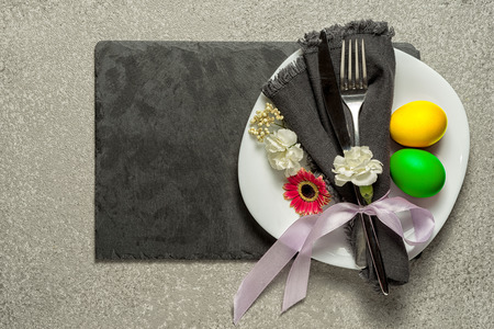 Easter table setting with flowers and cutlery. Holidays background.