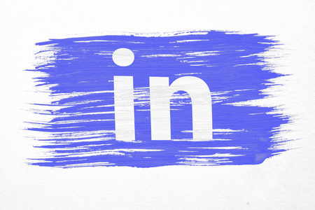 Moscow, Russia - March 24, 2018: closeup of art brush watercolor painting linkedin flag blown in the wind isolated on white. Logo animation. Linkedin is a business-oriented social networking service.のeditorial素材