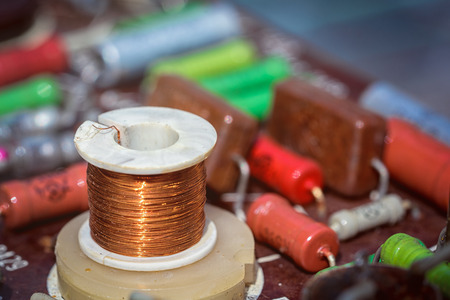 Induction coil with electronic components on an antique printed circuit board