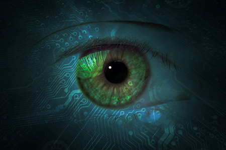 data eye with technical background. one eye glows on a circuit board pattern as a futuristic high technology concept.の写真素材