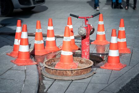 hydrant surrounded by cones on a carriagewayの写真素材