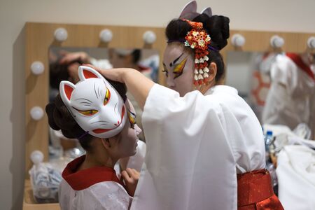 Backstage two actresses prepare for the stage performance.の写真素材