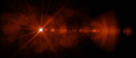Abstract red light flare special effect over black background. Sun with flare natural sunshine wallpaper.の写真素材