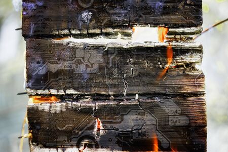 Burning log with silhouette of the computer motherboard.の写真素材