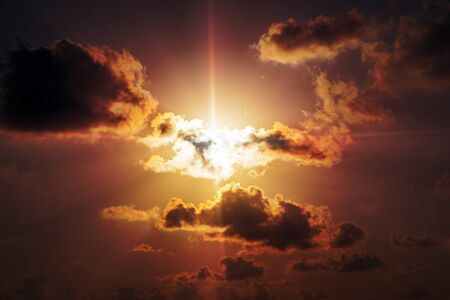 Sun, sunset, sunrise. Majestic clouds in the orange sky.