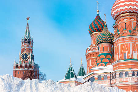 Snow pile near St. Basil's Cathedral and Spasskaya tower, winter in Moscow, Russia.の写真素材