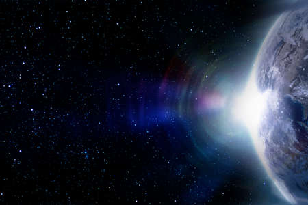 Planet Earth in space and lens flare from the rising sun.