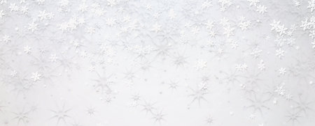 White snowflakes on white background. New Year and Christmas greeting card background with copy space.の写真素材