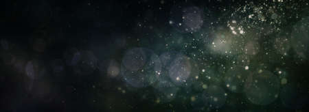 Abstract magic sparks light and snow circular bokeh New year Christmas background.の写真素材