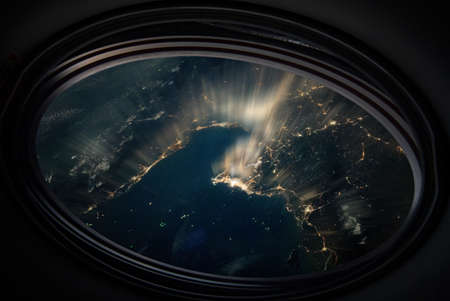 Bangkok night view from space. Light lines from portholeの写真素材