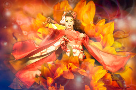 Japanese geisha with fan dancing with sunflowers background.の写真素材