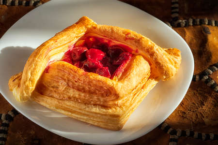 Puff with cherries on a plateの写真素材