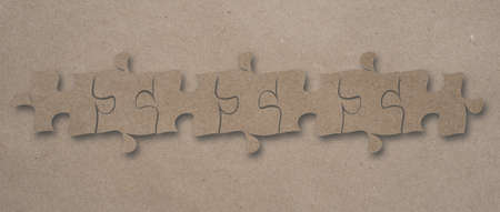 Top view flat lay of craft paper jigsaw puzzle game texture incomplete or missing piece, quiz calculation conceptの写真素材
