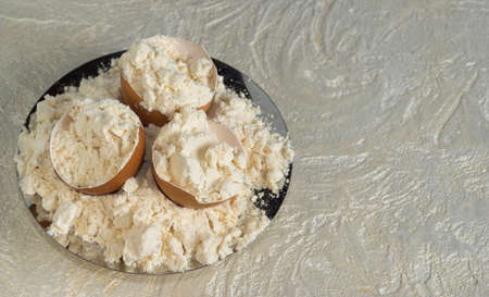 Egg protein powder on a plate and egg shells. Top view with copy space. sports nutrition.の写真素材